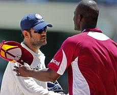 India's captain Mahendra Singh Dhoni, left, is congratulated by West Indies' captain Darren Sammy after India won the first cricket Test match by 63 runs on the fourth day in Kingston, Jamaica, Thursday June 23, 2011. AP