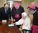 Pope Benedict XVI touches a touchpad to send a tweet for the launch of the Vatican news information portal ''www.news.va'', at the Vatican Tuesday. AP