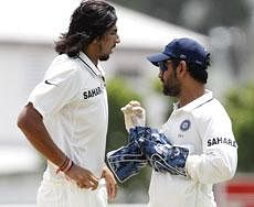 India's Ishant Sharma, left, talks with India's captain Mahendra Singh Dhoni, right, during the second day of the second cricket Test match against the West Indies in Bridgetown, Barbados, Wednesday, AP