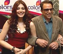 Actors Dharmendra and Sonali Bendre, judges of a TV show on talent, during a promotional event for the programme in New Delhi. PTI Photo