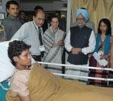 Prime Minister Manmohan Singh and Congress President Sonia Gandhi meets an injured of yesterday's serial blasts at Saifee Hospital in Mumbai on Thursday. PTI