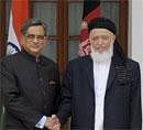 Foreign Minister S.M. Krishna, left, shakes hand with Afghanistan Chairman High Peace Council Burhanuddin Rabbani in New Delhi on Thursday. AP
