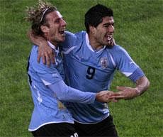 Uruguay's Luis Suarez, right, and Uruguay's Diego Forlan celebrate after Suarez scored against Peru during a Copa America semifinal soccer match in La Plata, Argentina, Tuesday, AP