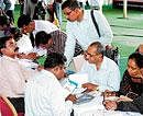 No longer taxing: People file their Income Tax returns at the Palace Grounds on Wednesday. DH Photo