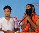 Balkrishna with Baba Ramdev. File Photo