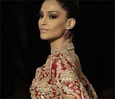 Bollywood actor Sonam Kapoor displays the creation of Indian designer Manish Malhotra during Delhi Couture Week 2011, in New Delhi on Sunday. AP