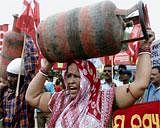 People carrying LPG cylinder during a protest against hike in fuel prices in Bhubaneswar on Saturday. PTI photo