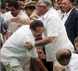 Karnataka Chief Minister Sadananda Gowda seeks blessings of his predecessor BS Yeddyurappa during his swearing-in ceremony at Raj Bhavan in Bangalore on Thursday. PTI