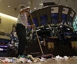A custodian sweeps the floor of the New York Stock Exchange after the closing bell, Wednesday,AP Photo