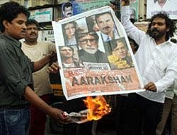 Bahujan Samaj Party activists burn posters of film ''Aarakshan'' during a protest in Thane, Mumbai on Thursday. PTI
