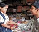 Affectionate: A sister tying a rakhi on her brothers wrist.