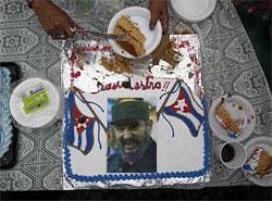 A woman serves up a piece of cake during a birthday celebration marking the 85th birthday of Cuba's former leader Fidel Castro in Managua, Nicaragua on Friday. AP