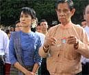 Myanmar democracy icon Aung San Suu Kyi, left, visits Shwemawdaw Pagoda on Sunday. AP