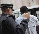 A metropolitan police officer arrests a riot suspect in London on August 11, 2011. AP File Photo