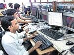 Brokers busy tracking the stock price movements on their monitors at the Bombay Stock Exchange, in Mumbai .PTI