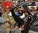 Pakistani Rangers soldier in black uniform and his Indian counterpart gestures during the "Beating the Retreat" or flag off ceremony on the Pakistan's independence Day on August 14, 2011 at the joint border check post Wagah near Lahore, AP