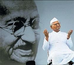 Under Bapus gaze: Anna Hazare at Ramlila Maidan in New Delhi with a portrait of  Mahatma Gandhi in the backdrop, on Friday. AFP