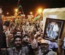 People celebrate the capture in Tripoli of Moammar Gadhafi's son and one-time heir apparent, Seif al-Islam, at the rebel-held town of Benghazi, Libya, early Monday. AP Photo