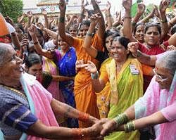 Women dance as they celebrate at Anna Hazare's village Ralegan Siddhi in Ahmednagar on Sunday after the Gandhian broke his fast. PTI Photo