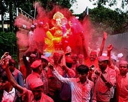 People carry a Ganesh idol to a pandal for the Ganesh festival in Thane. PTI File Photo