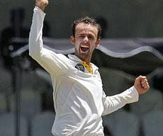 Australian bowler Nathan Lyon celebrates the dismissal of Sri Lanka's batsman Kumar Sangakkara, unseen, during the second day of the first test cricket match between Australia and Sri Lanka in Galle on Thursday. AP