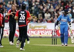 England's Stuart Broad, second left, asks the umpire to review his decision after he gave India's Rahul Dravid, right, not out during the first one day international cricket match at the Riverside Cricket Ground in Durham, England, Saturday, AP