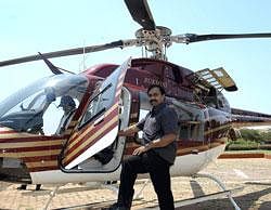 Janardhana Reddy with his chopper 'Rukmani' which was seized by CBI in Bangalore on Monday. File Photo/PTI
