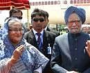 Prime Minister Manmohan Singh with his Bangladeshi counterpart Sheikh Hasina during his ceremonial welcome at Hazrat Shahjalal International Airport in Dhaka on Tuesday. PTI