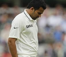 Zaheer Khan reacts after pulling up during his over during the first day of the first Test against England, at Lord's Cricket ground in London on July, 21, 2011. AP File Photo