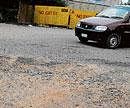 deplorable state: A bad and unmotorable stretch of a road in HSR Layout.. DH Photo