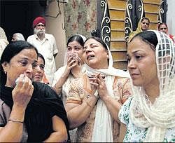 In grief: Relatives of blast victim Inder Singh mourn as his body is taken for funeral in New Delhi on Thursday. AP