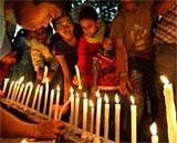 Children lighting candles for High Court blast victims as they take part in a programme "Literacy for Peace to Combat Terrorism" to mark Internal Literacy Day in New Delhi on Thursday. PTI Photo