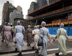 A group of Mennonite women from Pennsylvania walk outside the ground zero site in New York, Saturday, Sept. 10, 2011. AP