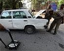 Police men checking a vehicle at a gate of the Delhi High Court in New Delhi on Saturday, PTI