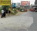 Crying for attention: The condition of the road in front of Yeshwanthpur Railway station. DH Photo