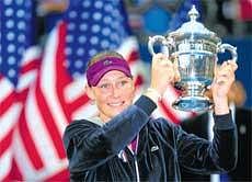 At Her Best: Australia's Samantha Stosur holds aloft the US Open title after beating Serena Williams in an ill-tempered final on Sunday. AFP