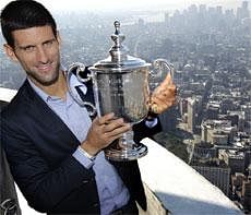 Novak Djokovic, of Serbia, poses with his U.S. Open trophy at the top of the Empire State Building in New York, Tuesday . AP