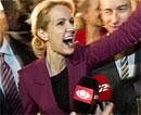 Helle Thorning-Schmidt, leader of the Danish Social Democrats and likely to be new prime minister talks to her party fellows after her coalition won the election in Copenhagen, Denmark on Thursday, AP