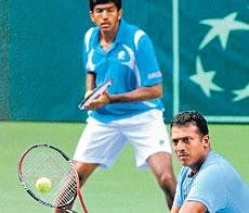 Back In Business: Mahesh Bhupathi (foreground) volleys as partner Rohan Bopanna watches on during their doubles tie against Japan on Saturday. AP