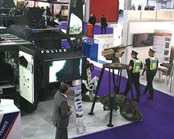 Police walk past a French Panhard armored personnel vehicle, with police markings to underscore its use beyond traditional battle fields as the Defence & Security Equipment International show gets underway in London, Tuesday Sept. 13, 2011. Billed as the largest world's arms fair: 1,200 defense manufacturers converge in London to show everything from the latest unmanned aircraft to camouflage body paint. (AP Photo)