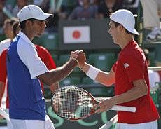Vishnu Vardhan of India, left, shakes hands with Kei Nishikori of Japan at the net after his loss to Nishikori, at the Davis Cup World Group Playoff Japan vs India in Tokyo, Sunday, Sept. 18, 2011. Team Japan defeated India 4-1.AP Photo