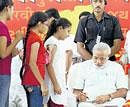 Schoolchildren seek autograph of Gujarat Chief Minister Narendra Modi on the second day of his fast in Ahmedabad on Sunday. PTI