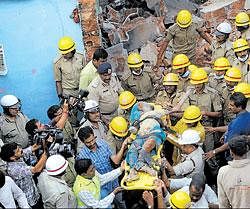 Firemen carry the body of Kavita from the rubble of a marriage hall which  collapsed after a suspected LPG&#8200;cylinder blast at Sumanahalli near Magadi Road in Bangalore on Wednesday. DH&#8200;Photo/ B H Shivakumar