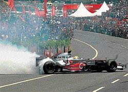 Rubber burning: Mclaren Mercedes Driver Lewis Hamilton drives the award-winning  MP4-23 car during the Formula One car run on NICE Road in Bangalore on Tuesday. PTI