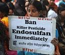 An activist from National Federation of Indian Women holds a placard during a protest in solidarity with victims of the pesticide Endosulfan in New Delhi on December 10, 2010. File Photo/AFP