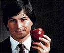 A younger Steve Jobs with an Apple.