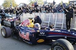 German F1 world champion Sebastian Vettel drives his car past supporters during a visit to his hometown Heppenheim, Germany, Saturday, AP