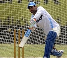 Indian cricket captain Mahendra Singh Dhoni plays a shot at the nets during a training session on the eve of a T20 match between India and England at The Eden Gardens Cricket Stadium in Kolkata. AFP