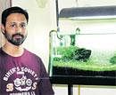 Talented: Nitin Mascreen alongside a fish tank made by him. DH Photos by M S Manjunath