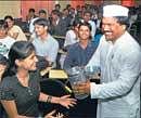 Six sigma effect: Pawan G Aggarwal, CEO of the Mumbai Dabbawallah Association, interacts with the postgraduate students at SNR Adarsh College in Bangalore on Wednesday. DH Photo